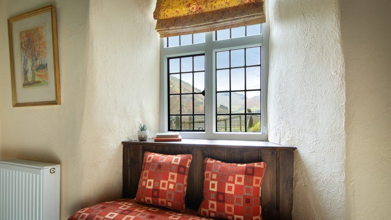 The window seat in the sitting room at Fron Dirion, with valley views of Eyri (Snowdonia), Powys